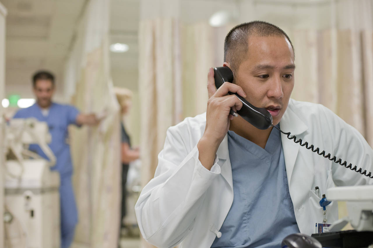 Clinician on a phone call, representing AllMed AI voice agents
